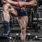 Man with muscular leaning on gym equipment