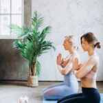 Two women relaxing doing Yoga