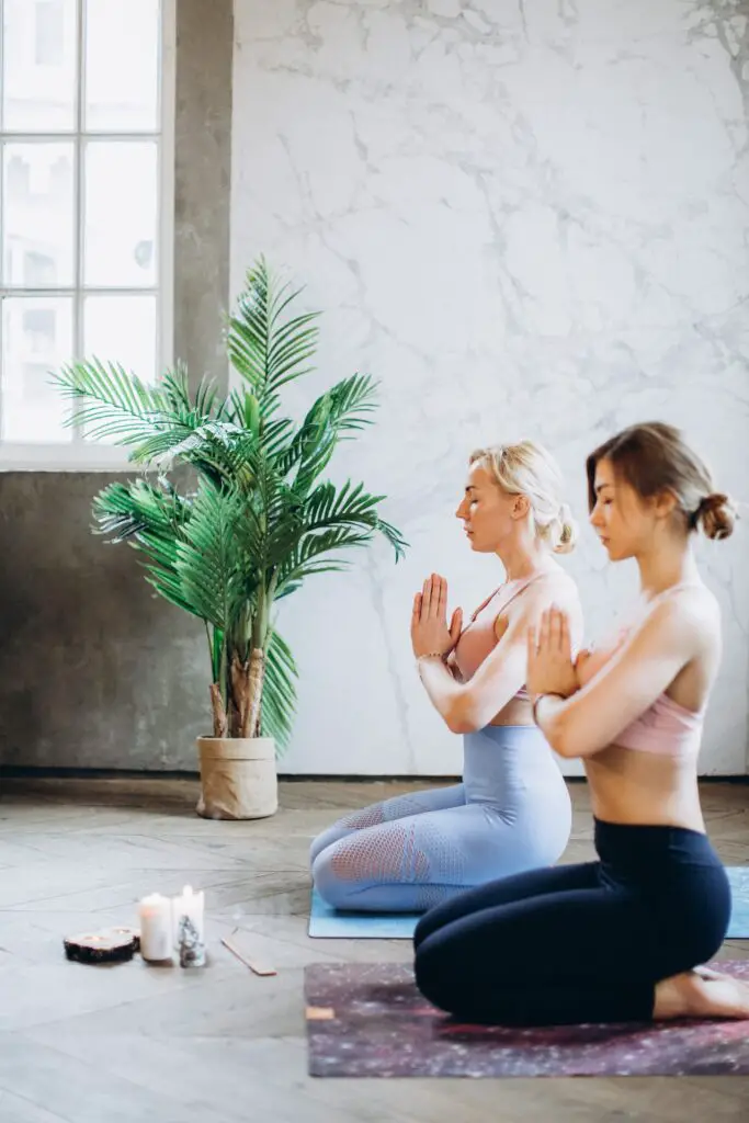Two women relaxing doing Yoga