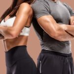 Man and woman side by side flexing chest muscles