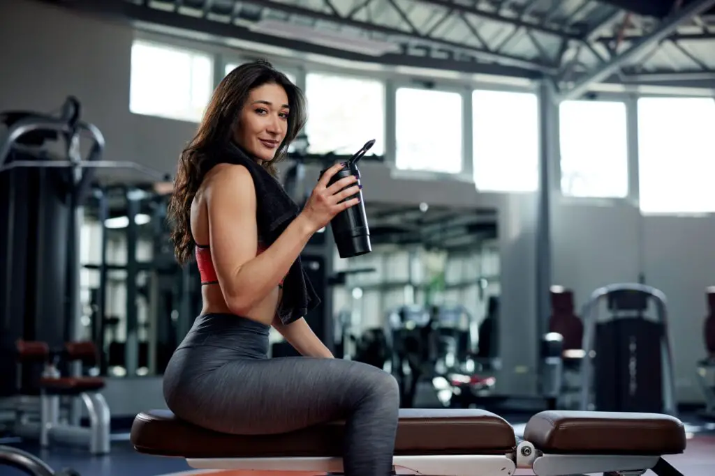 Woman drinking a pre-workout