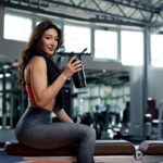 Woman drinking a pre-workout